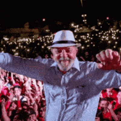 Man In Hat With Arms Outstretched Before Crowd GIF