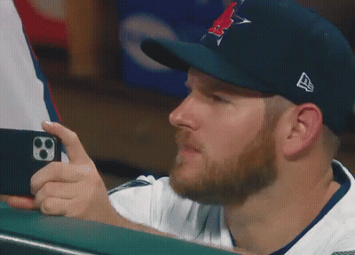 Man In Hat With Letter A Looking At Phone GIF