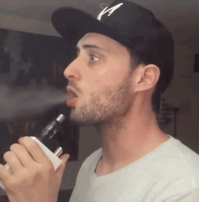 Man In Hat With Letter A Smoking E-Cigarette GIF