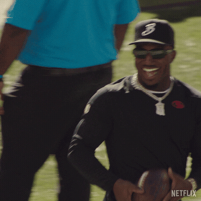 Man In Hat With Letter B Holding Football GIF