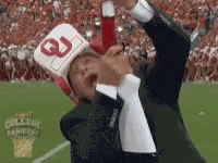 Man In Hat With Letter G Holding Bottle GIF