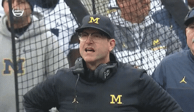 Man In Hat With Letter M In Front Of Fence GIF