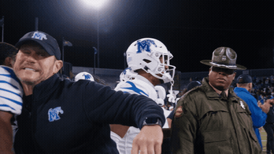 Man In Hat With Letter M Next To Football Player GIF