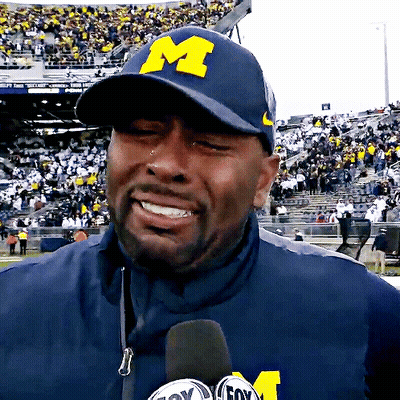 Man In Hat With Letter M Talking Into Microphone GIF