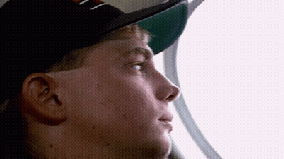 Man In Hat With Letter N Looking Out Window GIF