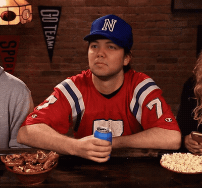 Man In Hat With Letter N Sitting At Table GIF