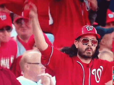 Man In Hat With Letter W In Crowd GIF