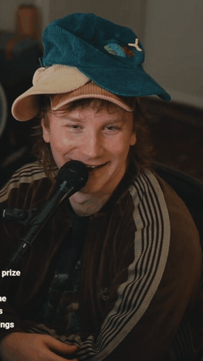 Man In Hat With Letter Y Holding Microphone GIF