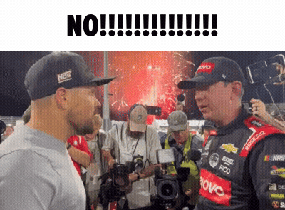 Man In Hat With Nos Talks To Another GIF