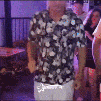 Man In Hawaiian Shirt Dancing In Dark Room GIF