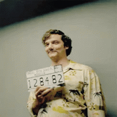Man In Hawaiian Shirt Holding License Plate 128482 GIF