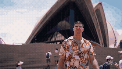 Man In Hawaiian Shirt On Stairs In Front Of Building GIF