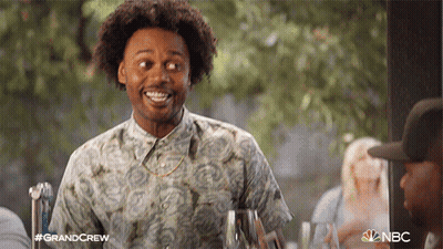 Man In Hawaiian Shirt Smiling Holding Wine GIF