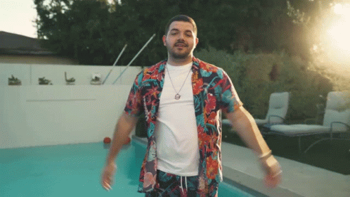 Man In Hawaiian Shirt Standing In Front Of Pool GIF