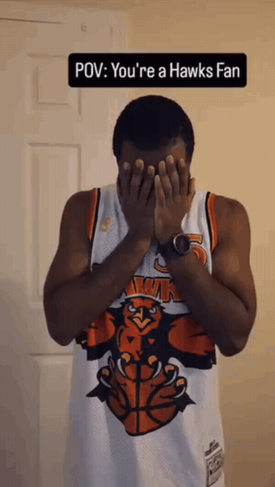Man In Hawks Jersey Covering Face With Hands GIF