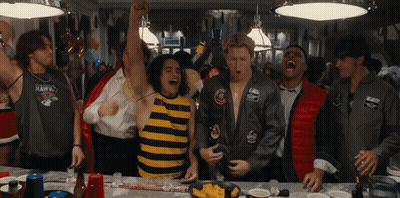 Man In Hawks Shirt Surrounded By People GIF