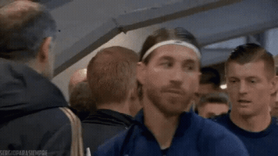 Man In Headband And Blue Jacket Standing In Crowd GIF