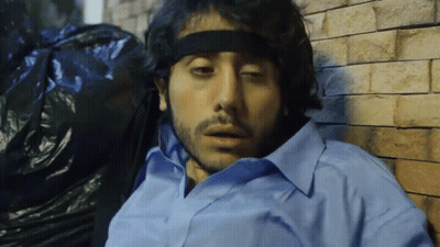 Man In Headband And Blue Shirt Laying Down GIF