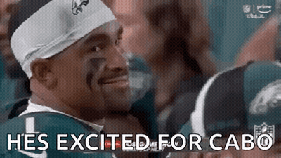 Man In Headband And Football Jersey Smiling GIF