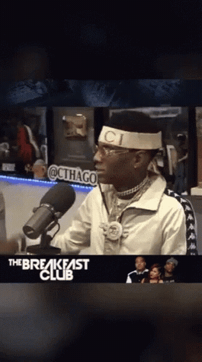 Man In Headband Saying Ci In Front Of Microphone GIF