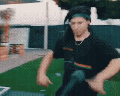 Man In Headphones And Bandana Dancing In Field GIF