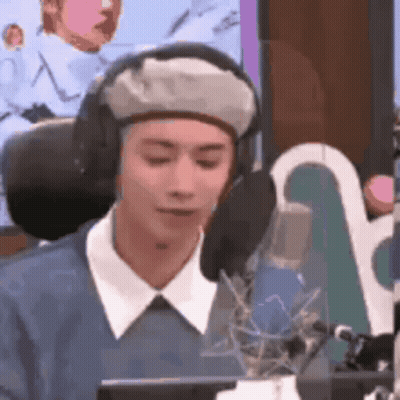 Man In Headphones And Beret Talking Into Microphone GIF
