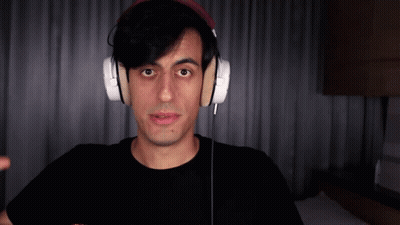 Man In Headphones And Black Shirt Looking At Camera GIF