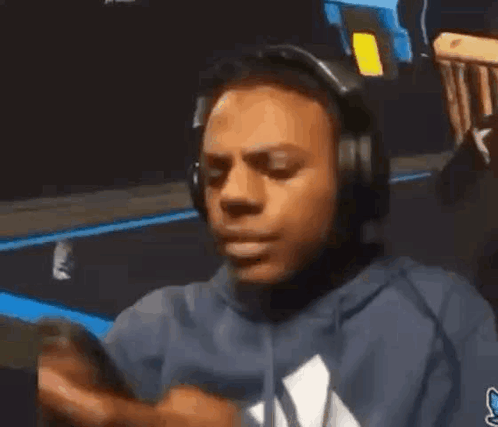 Man In Headphones And Blue Hoodie On Phone GIF