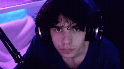 Man In Headphones And Blue Shirt Pointing At Camera GIF