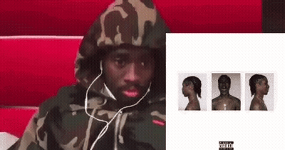 Man In Headphones And Camouflage Hoodie On Red Chair GIF