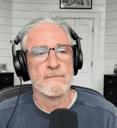 Man In Headphones And Glasses At Microphone GIF
