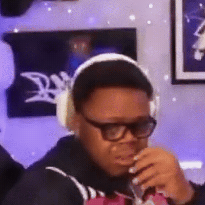 Man In Headphones And Glasses Drinking GIF
