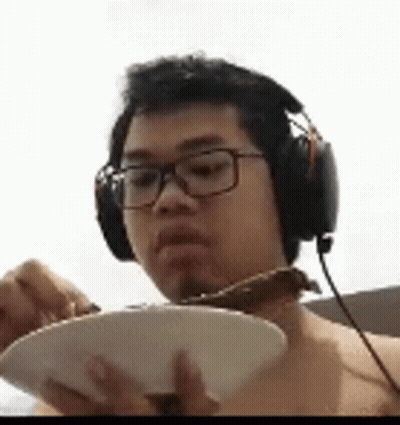 Man In Headphones And Glasses Eating From Bowl GIF