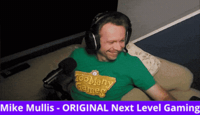 Man In Headphones And Green Shirt With Too Many Games GIF