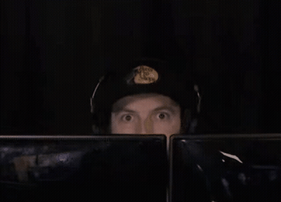 Man In Headphones And Hat At Two Monitors GIF