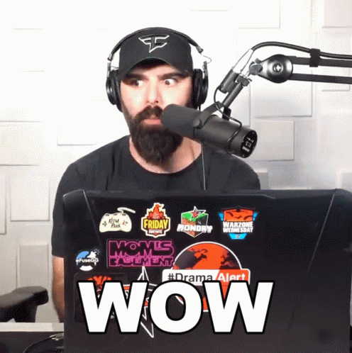 Man In Headphones And Hat In Front Of Microphone And Laptop Says Wow GIF