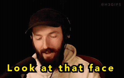 Man in Headphones and Hat Looking at Camera