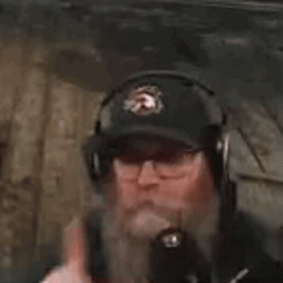 Man In Headphones And Hat Smoking Cigarette In Dark Room GIF