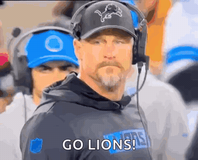 Man in Headphones and Hat With Lion Says Go Lions
