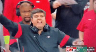Man In Headphones And Jacket With Letter G Watching Football GIF