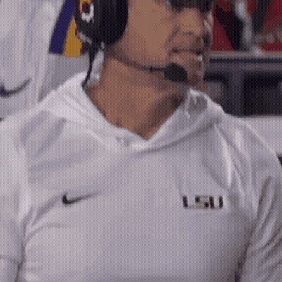 Man In Headphones And LSU Shirt Watching Football GIF