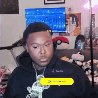 Man In Headphones And Mickey Mouse Necklace On Couch GIF