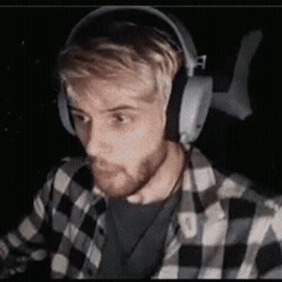 Man In Headphones And Plaid Shirt Sitting GIF