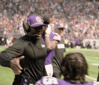 Man In Headphones And Purple Hat On Football Field GIF