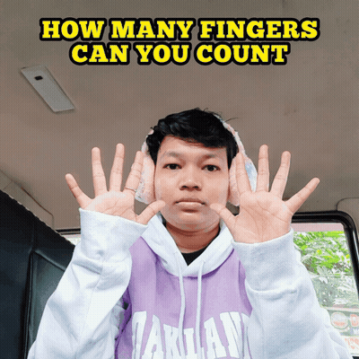 Man In Headphones And Purple Takuan Sweatshirt Holding Up Fingers GIF