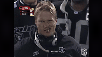 Man In Headphones And Raiders Jacket Looking At Camera GIF