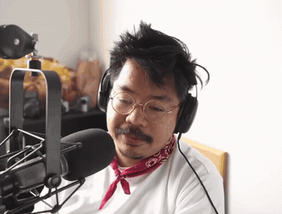 Man In Headphones And Red Bandana Talking Into Microphone GIF