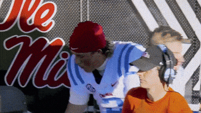 Man In Headphones And Red Beanie At Ole Miss Sign GIF