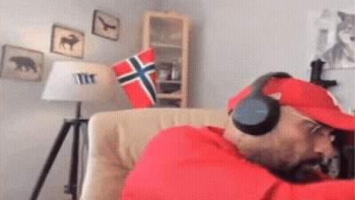 Man In Headphones And Red Hat Sitting In Chair GIF
