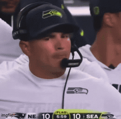 Man In Headphones And Seahawks Hat Watching Football GIF